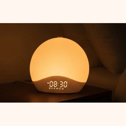 Sunla on a bedside table in a dark bedroom, its warm amber glow the only light in the room